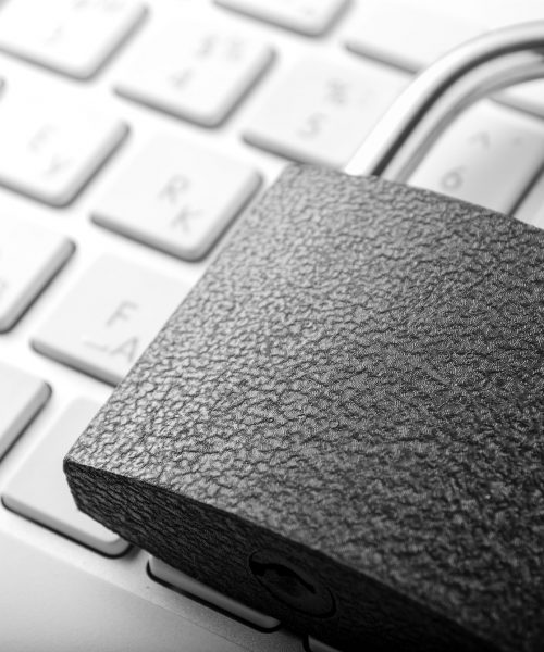 Padlock lying on the computer-keyboard
